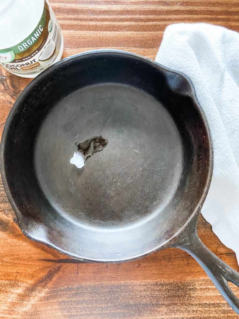 cast iron skillet with dollop of coconut oil