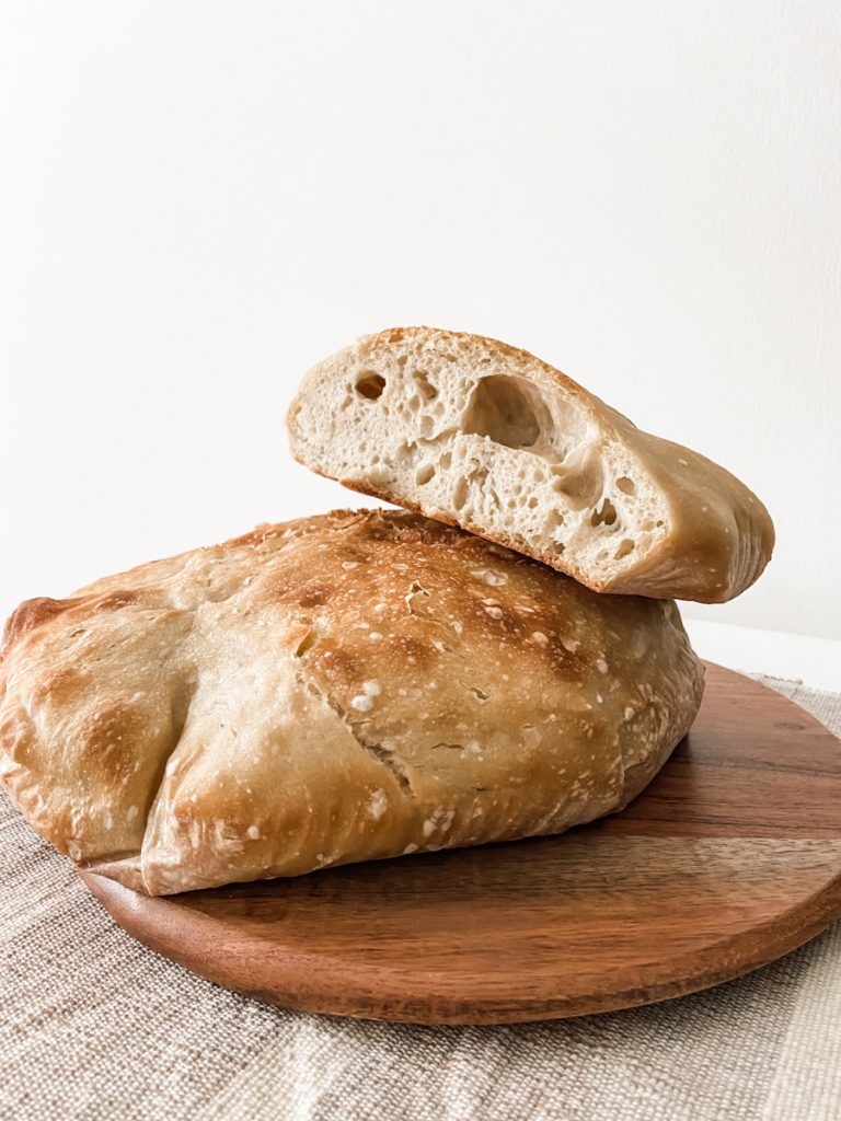 flat sourdough loaves on cutting board