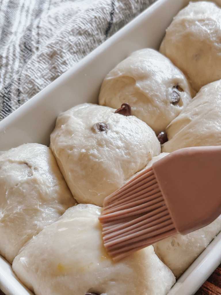 chocolate chip brioche dough being brushed with egg wash