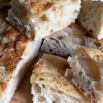 focaccia bread sliced and stacked on a cutting board