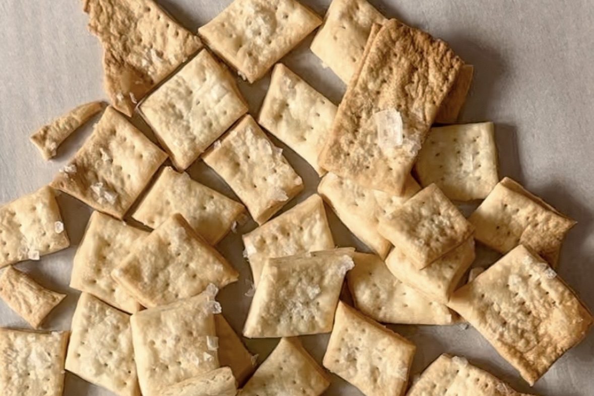 sourdough crackers on a sheet of parchment paper