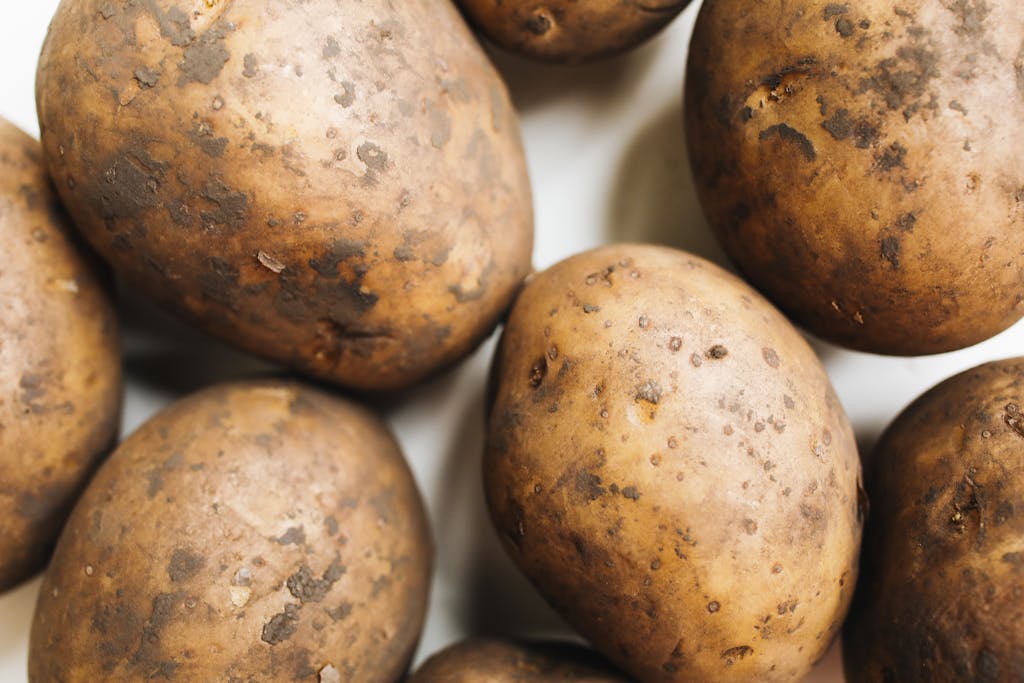 A close-up view of freshly harvested potatoes showcasing their natural texture and rustic appearance.