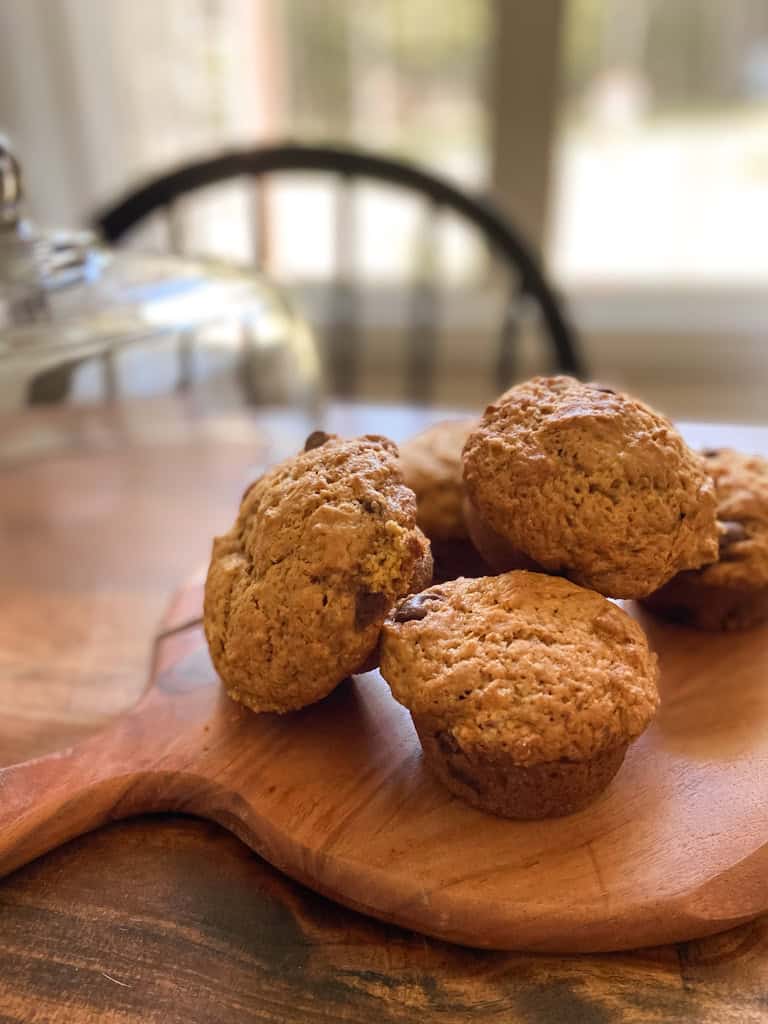 sourdough pumpkin chocolate chip muffins on a cutting board