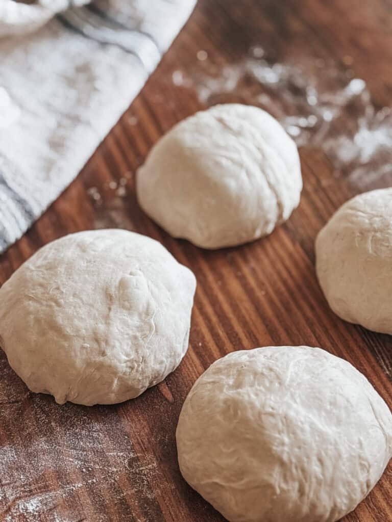 shaped pizza dough balls on a table