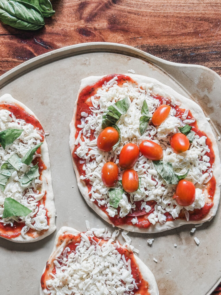 3 sourdough pizzas on a pizza stone