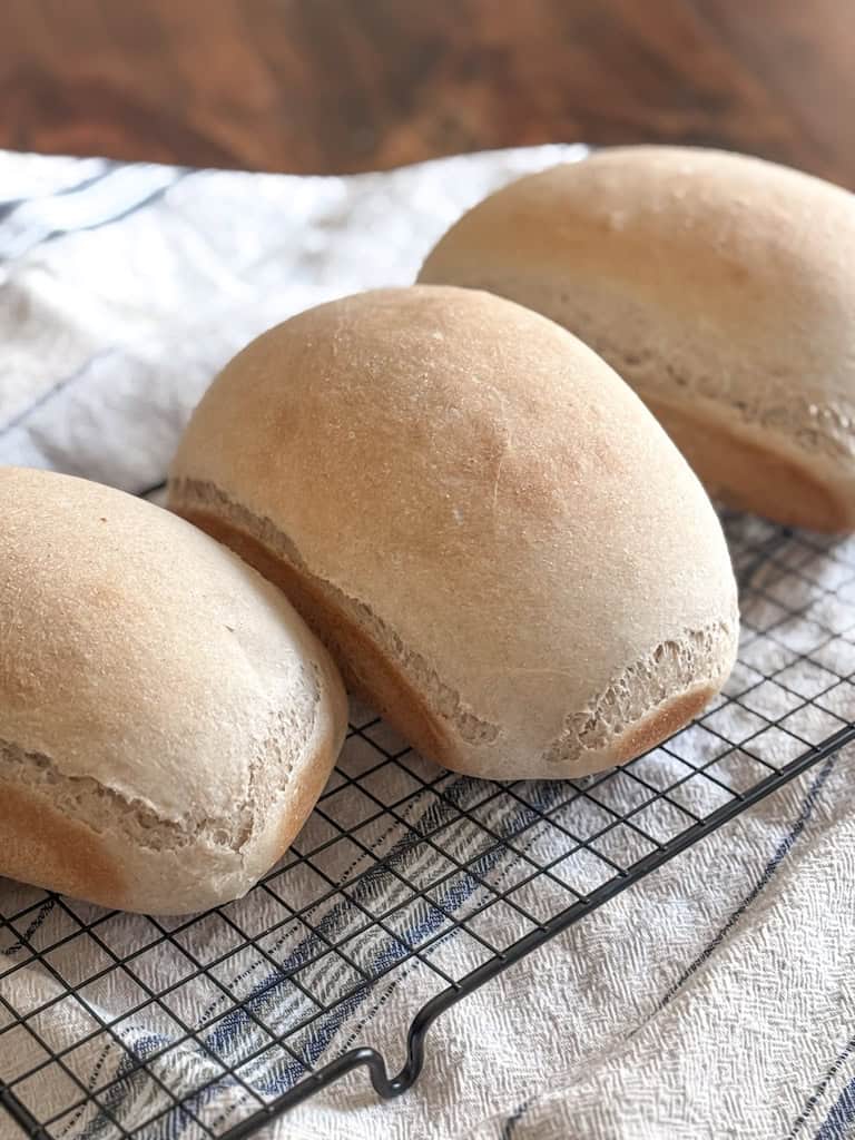 loaves of sandwich bread on a cooling rack