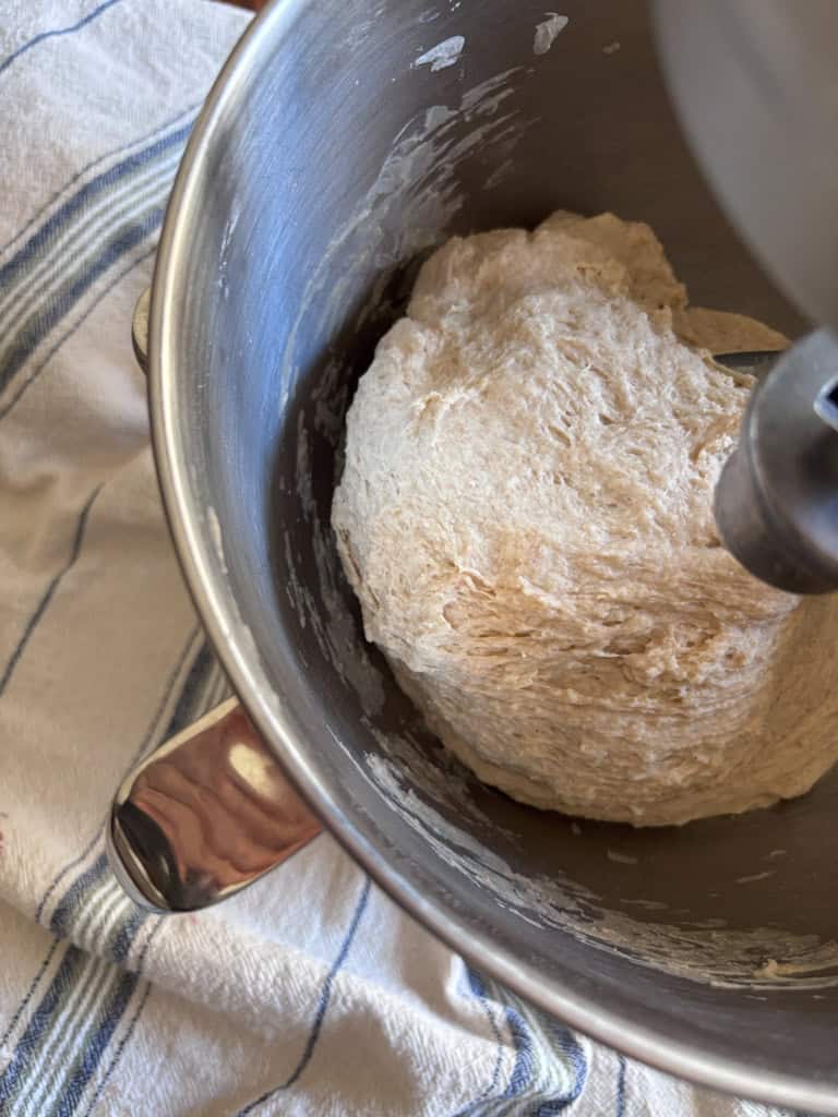 bread dough being mixed in stand mixer