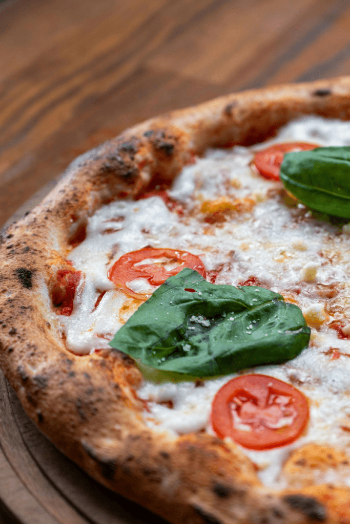 close up of pizza tomatoes and basil