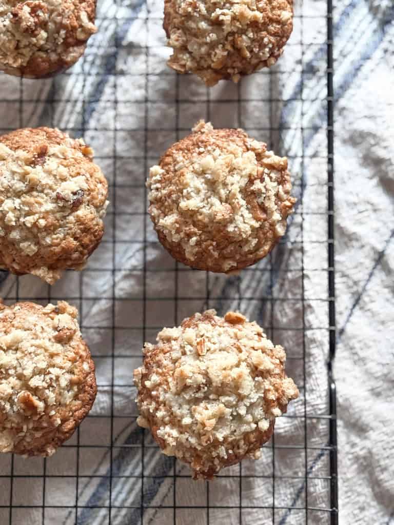 sourdough banana muffins on a black wire cooling rack