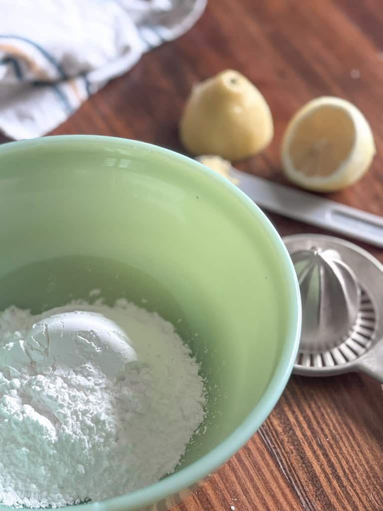 green bowl with powdered sugar