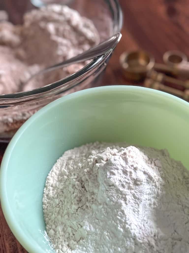 green bowl with dry ingredints for sourdough coffe cake