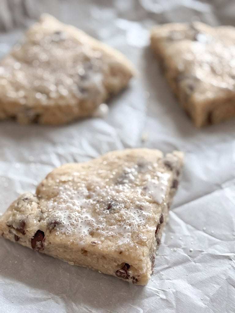 close up of heavy cream and sugar sprinkled on sourdough scones