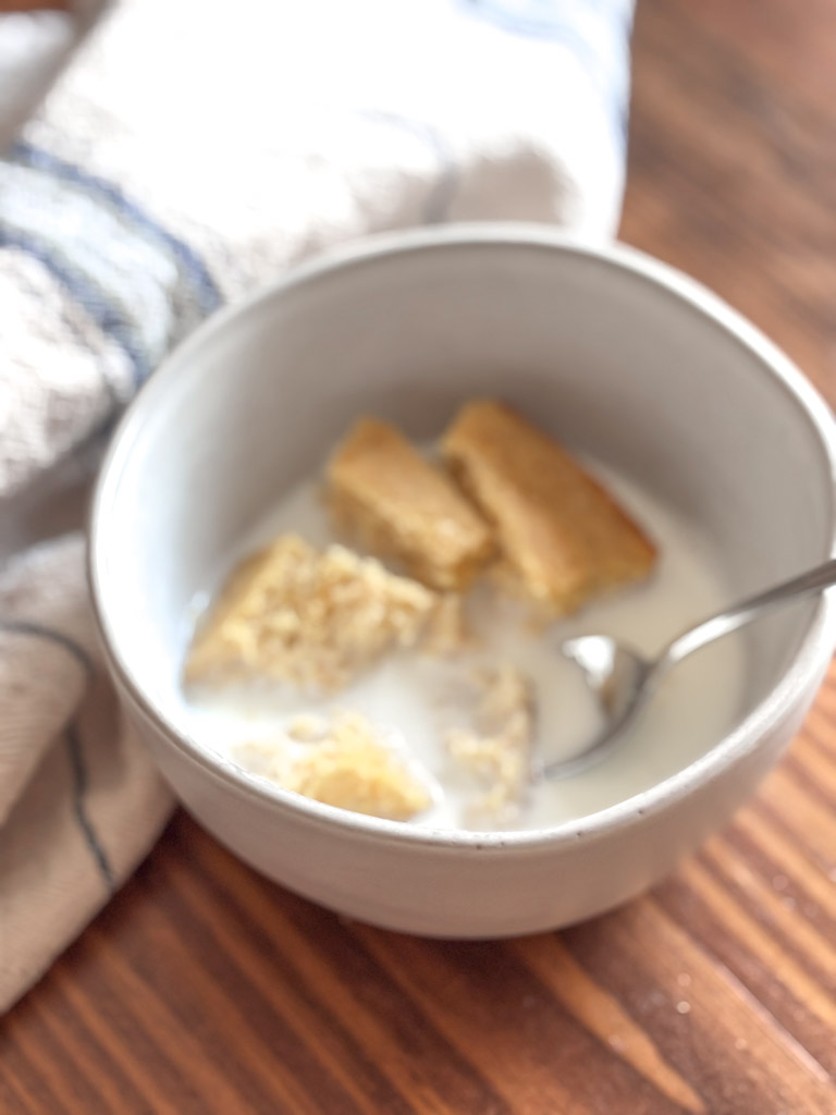 bowl of cornbread and milk on a table