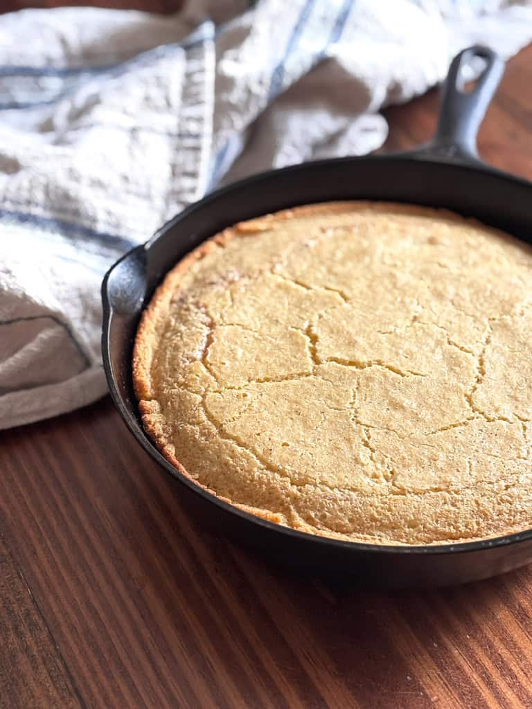 cast iron skillet of southern style cornbread on a table