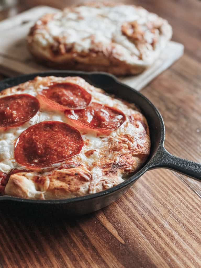 deep dish pepperoni pizza in a cast iron skillet