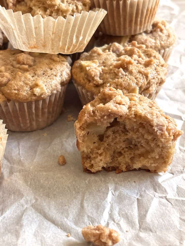 close up of sourdough discard apple muffin inside on parchment paper
