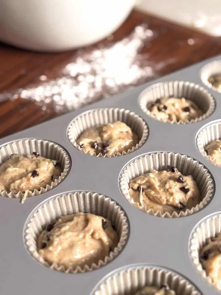 zucchini chocolate chip muffin batter in muffin tin
