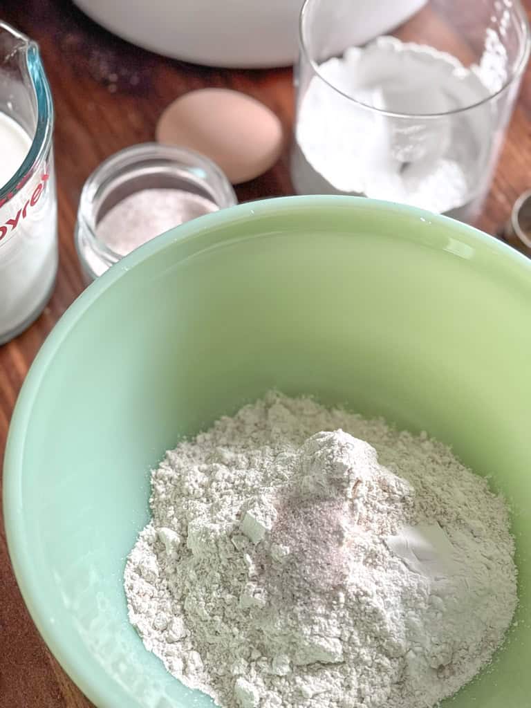 green bowl of fresh milled flour with salt
