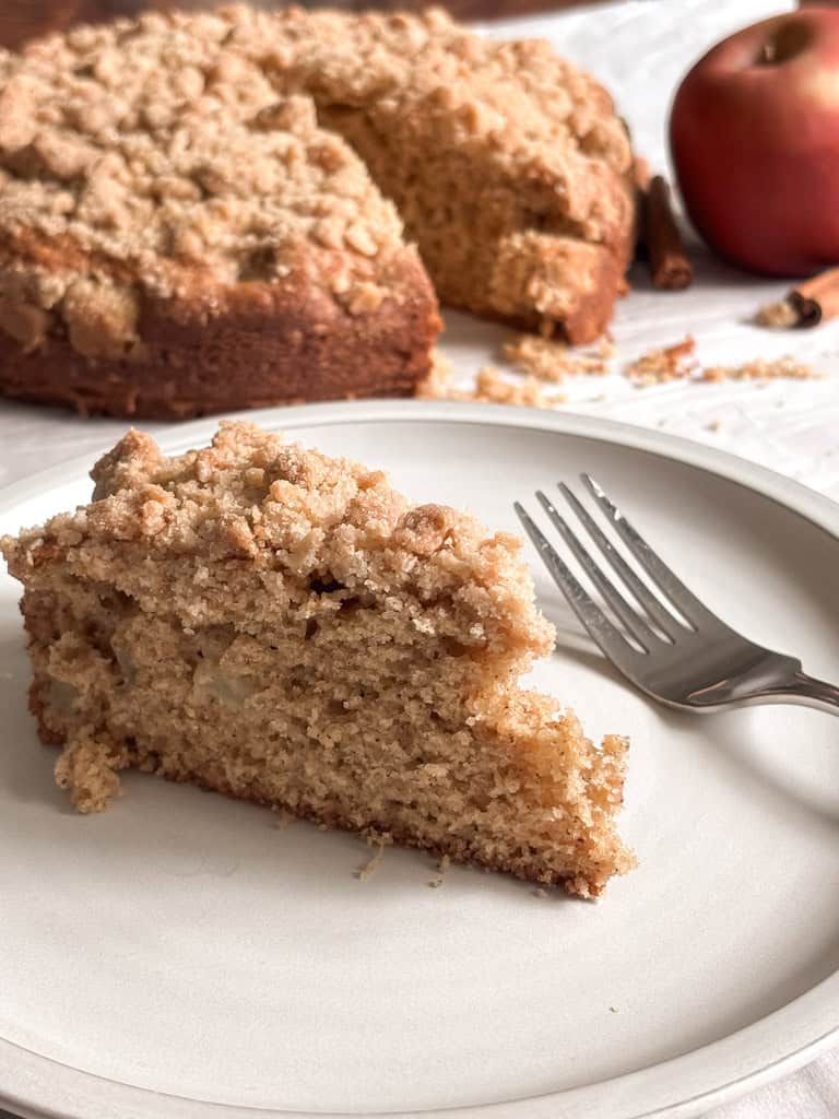 slice of apple cake on a plate with a fork