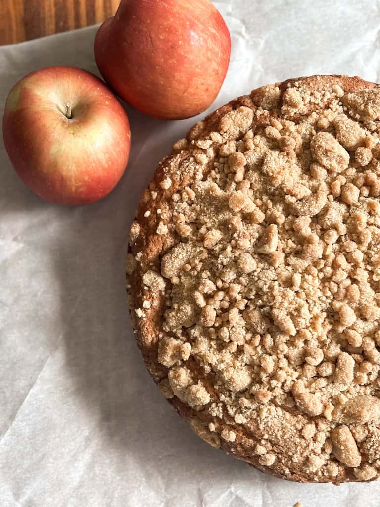 top view of apple cake on a piece of white parchment paper