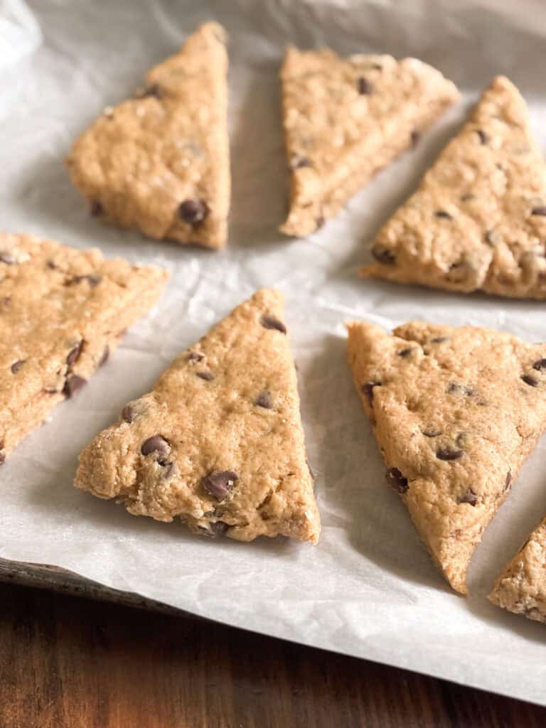 unbaked pumpkin chocolate chip scones on a sheet of parchment