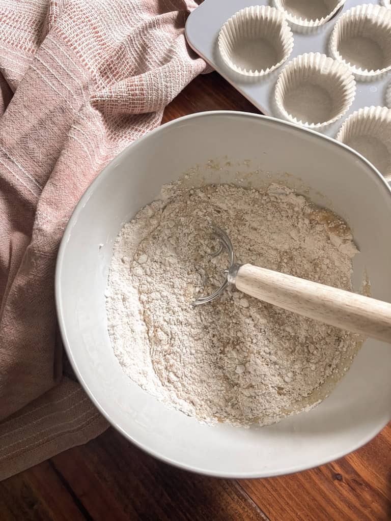 dry ingredients in a bowl beside a muffin pan
